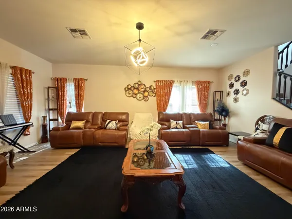 a living room with furniture and a chandelier