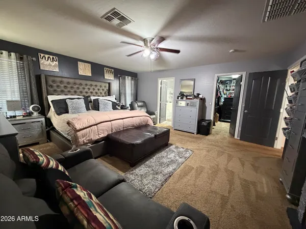 a bedroom with a bed and a mirror