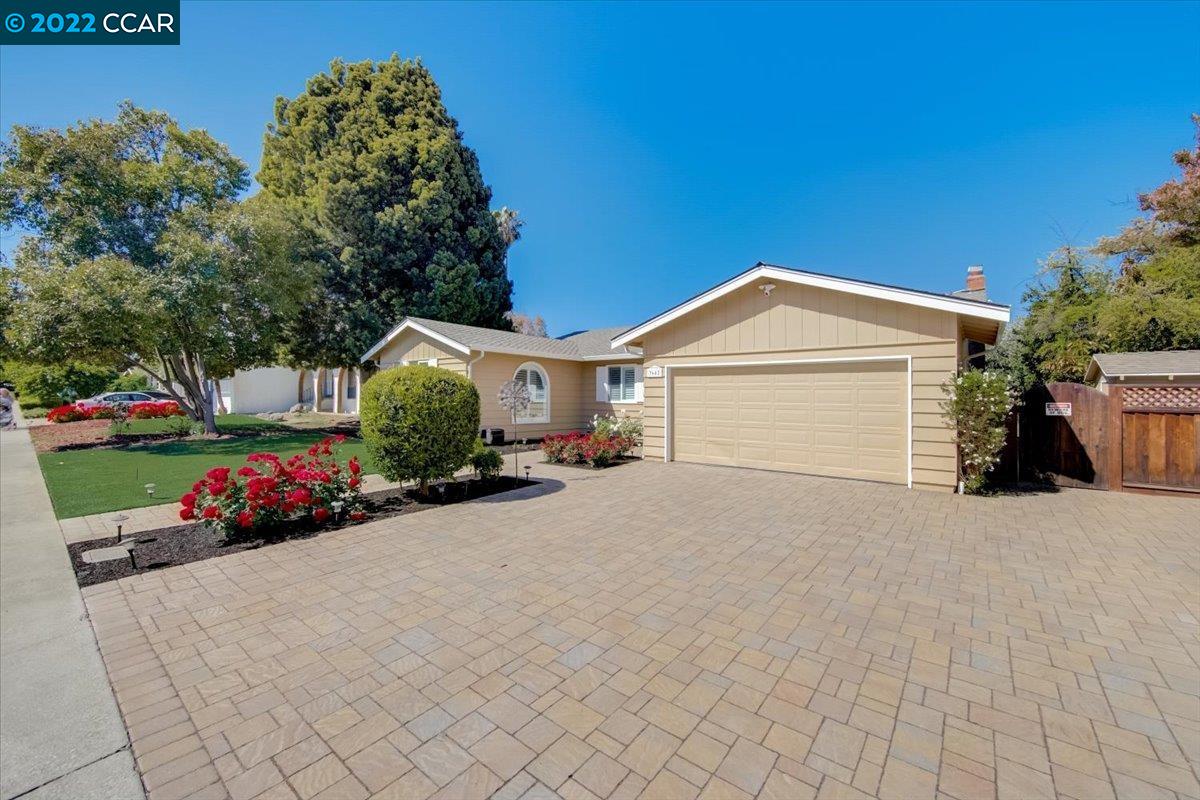 a view of a house with a yard and garage