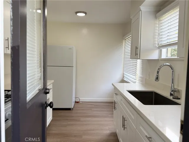 a kitchen with a sink and a refrigerator