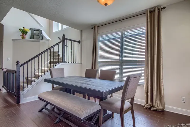 a view of a dining room with furniture window and wooden floor
