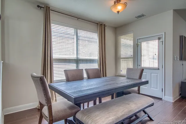 a view of a dining room with furniture and wooden floor