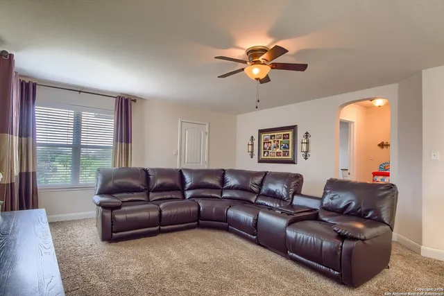 a living room with furniture and a large window