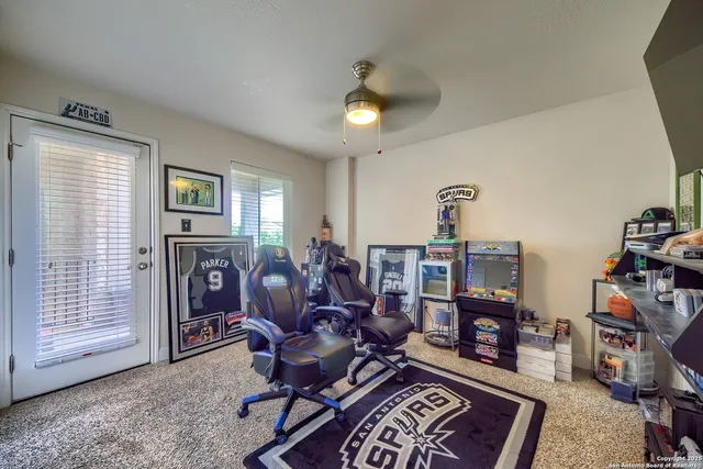 a living room with furniture a fireplace and a window