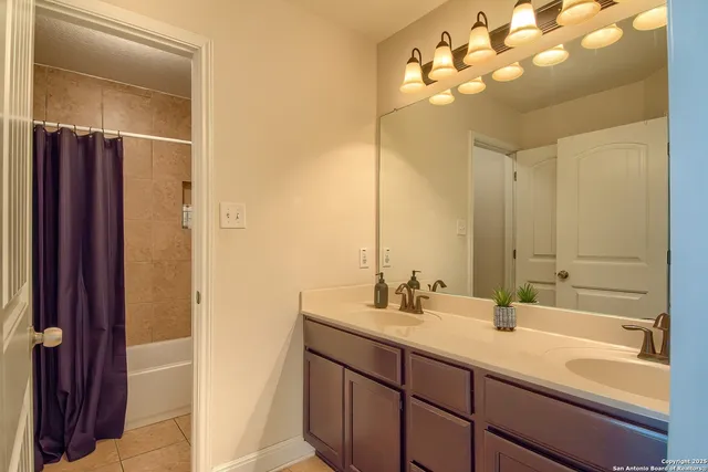 a bathroom with a sink double vanity and a mirror