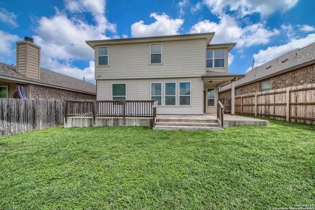 a view of a house with a backyard