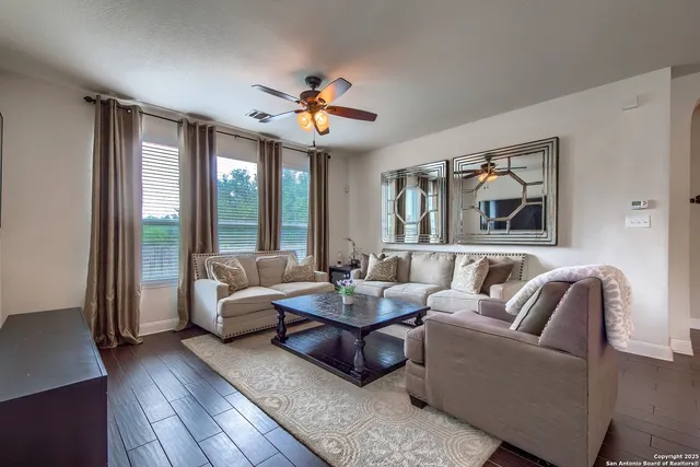 a living room with furniture and a large window