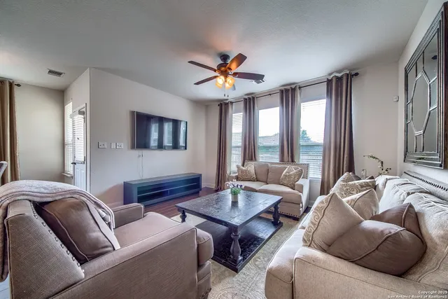a living room with furniture and a large window