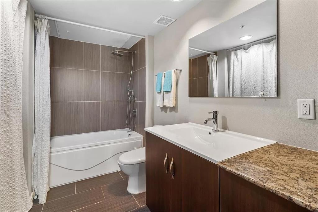 1100 West Trinity Mills Road Carrollton, TX 75006 - Photo 21 of 30 a bathroom with a sink a toilet and shower