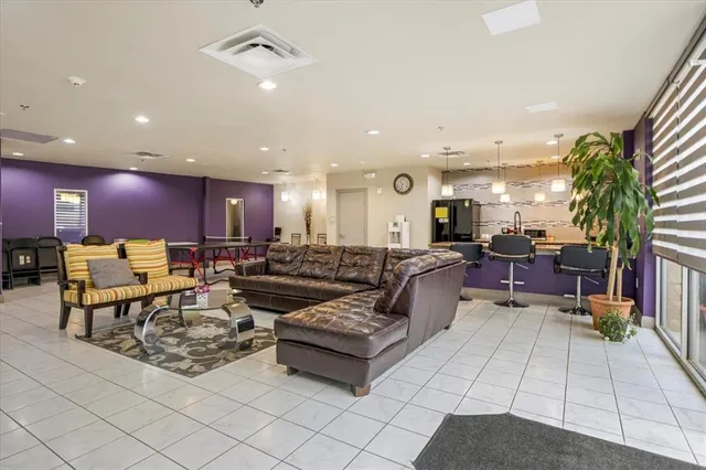 a living room with lots of furniture and a potted plant