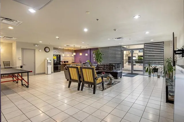 a living room with furniture a dining table and kitchen view
