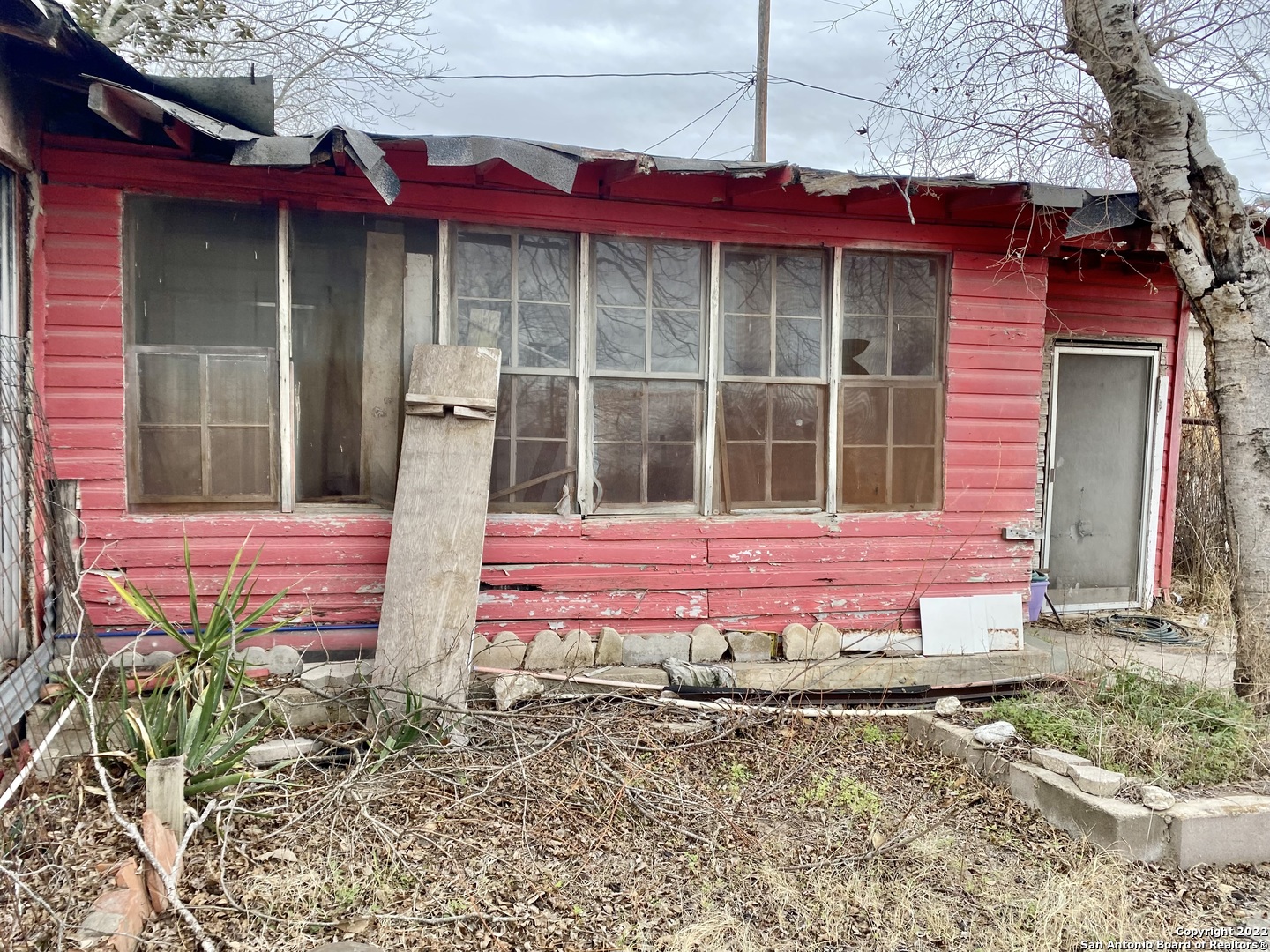 614 4th Street Natalia, TX 78059 - Photo 2 of 8 a view of a small house in the middle of a yard