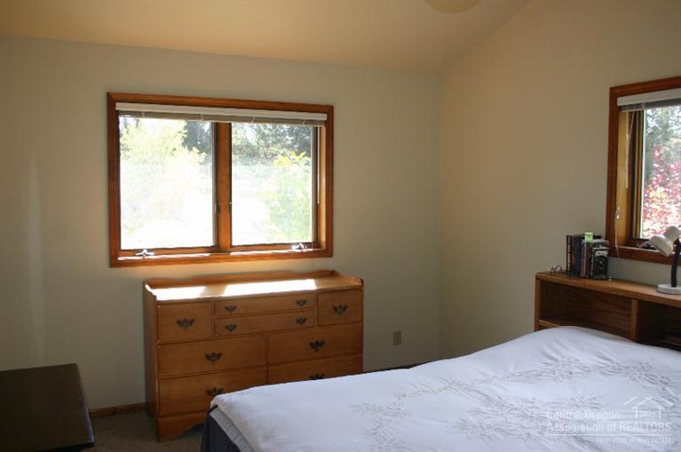 63488 Abbey Road Bend, OR 97701 - Photo 12 of 25 a bedroom with a bed and a window