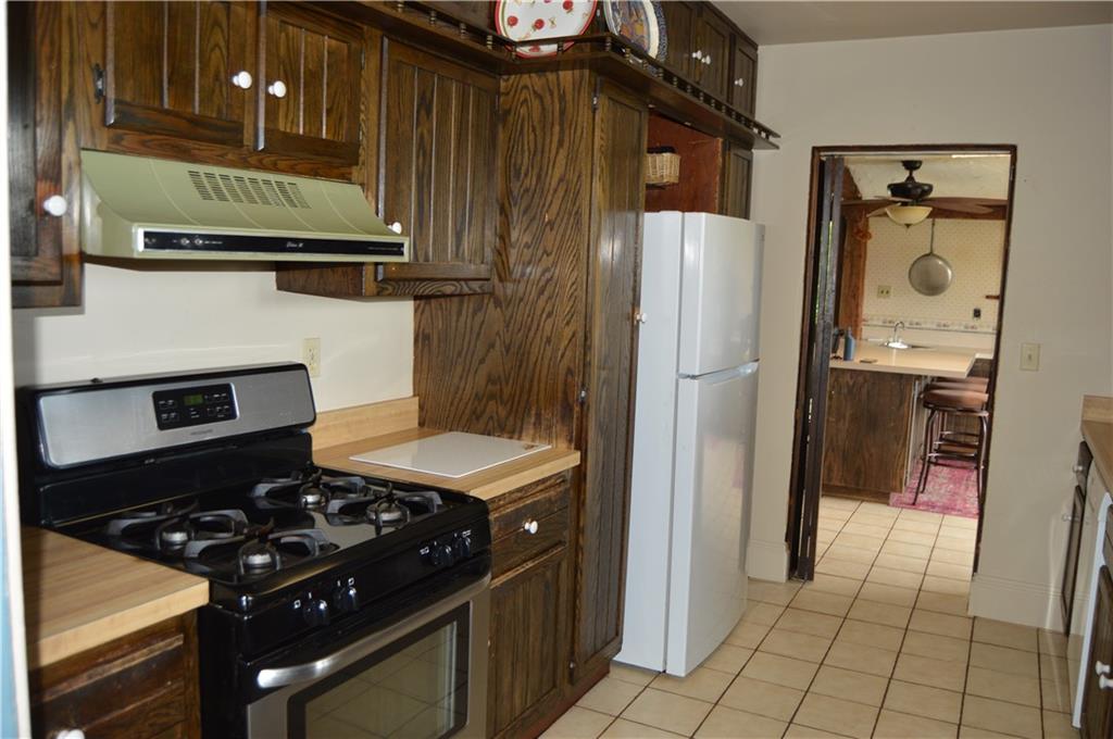1098 Burtner Road Natrona Heights, PA 15065 - Photo 13 of 25 a kitchen with stainless steel appliances granite countertop a refrigerator and a stove