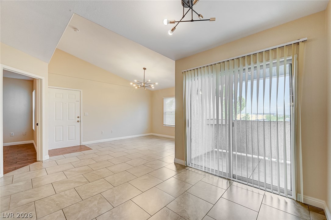 7255 West Sunset Road, Unit 2005 Las Vegas, NV 89113 - Photo 15 of 27 An inviting open-concept living space features vaulted ceilings and direct balcony access.