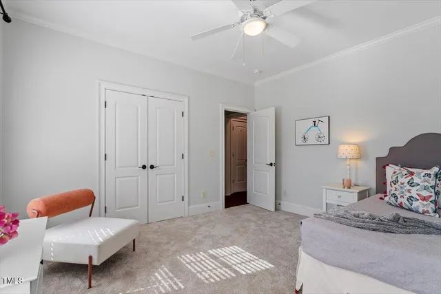 a spacious bedroom with a bed and a chandelier