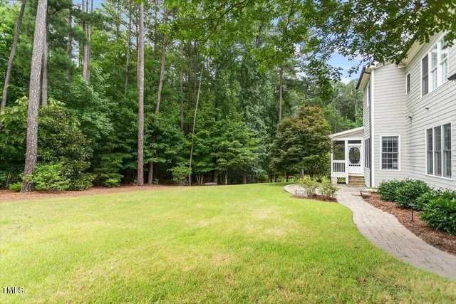 a swimming pool with outdoor seating and yard