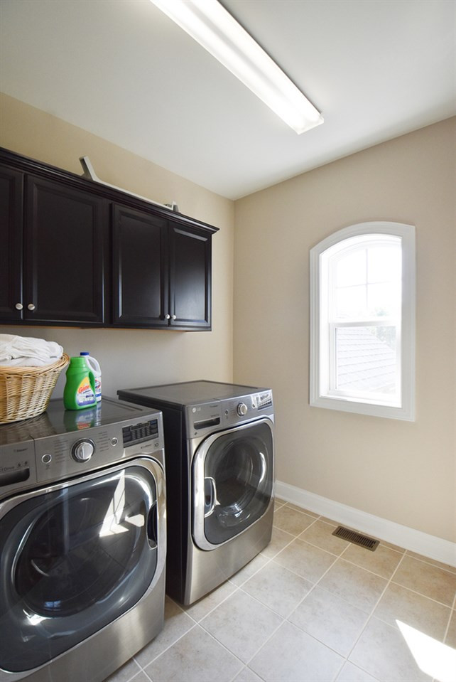 2008 Bowling Green Trail Raleigh, NC 27613 - Photo 25 of 30 Off the Bonus Rm/Loft is the bright Laundry Rm w/neutral tile floor & wall cabinets. Laundry Rm