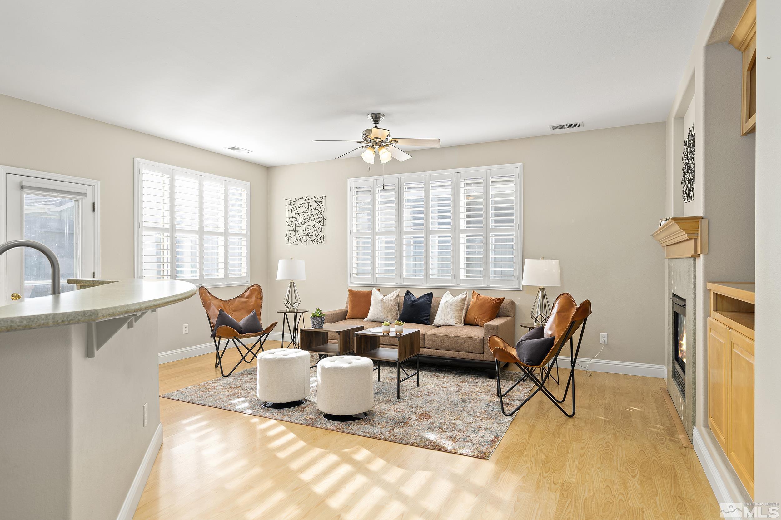 1474 Diamond Country Drive Reno, NV 89521 - Photo 14 of 38 a living room with furniture a fireplace and large windows
