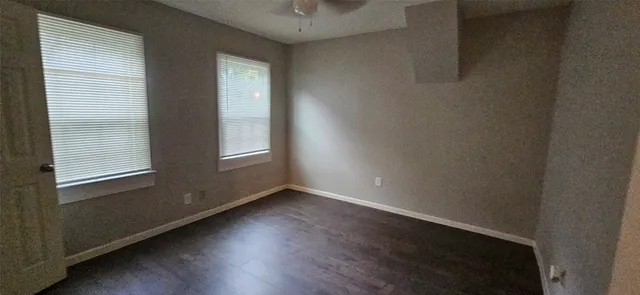 a view of a small space with wooden floor and a window