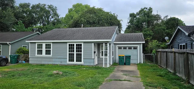 a aerial view of a house with yard and deck