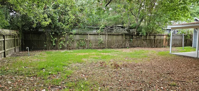 a view of a backyard with a small cabin and a fountain