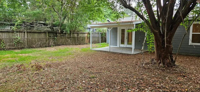 a front view of a house with a yard and lake view