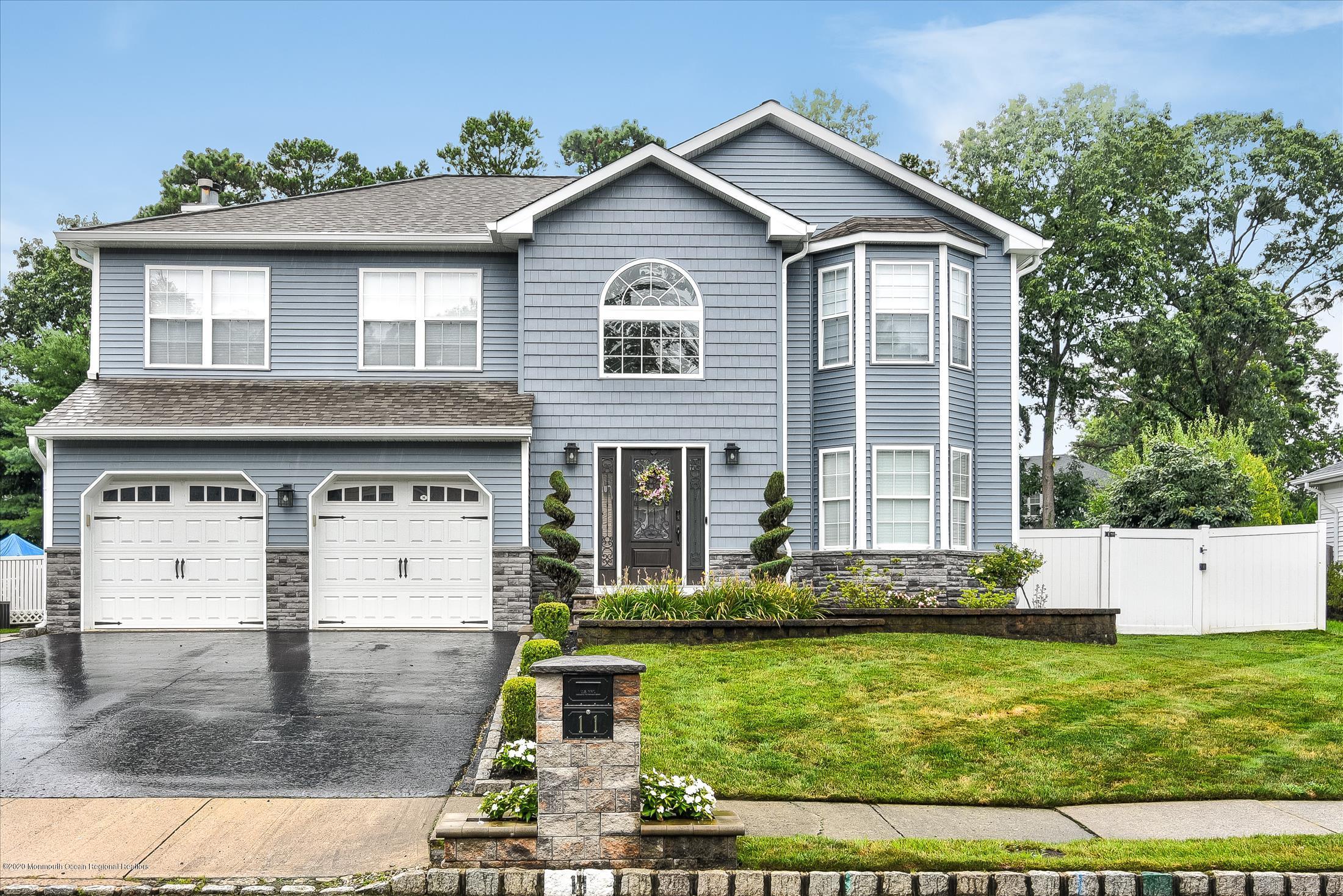 11 Sun Hollow Road Howell, NJ 07731 - Photo 1 of 27 a front view of a house with garden