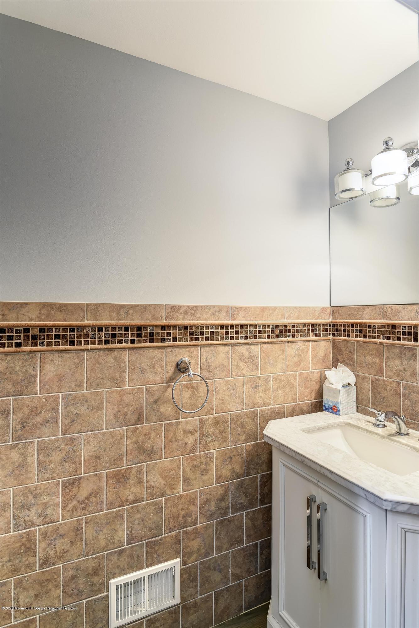 11 Sun Hollow Road Howell, NJ 07731 - Photo 13 of 27 a bathroom with a granite countertop sink and a mirror