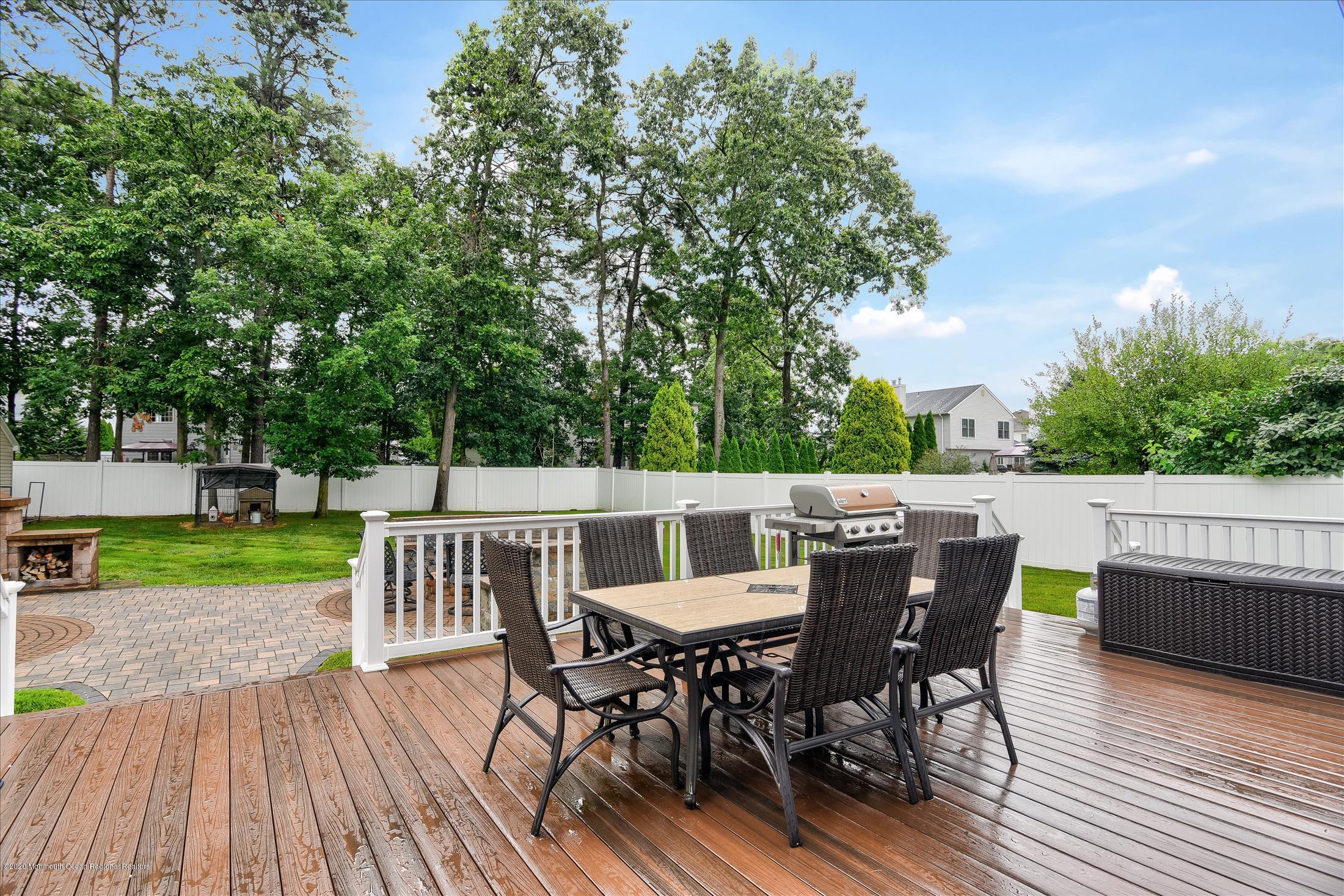 11 Sun Hollow Road Howell, NJ 07731 - Photo 23 of 27 a view of a deck with table and chairs and wooden floor