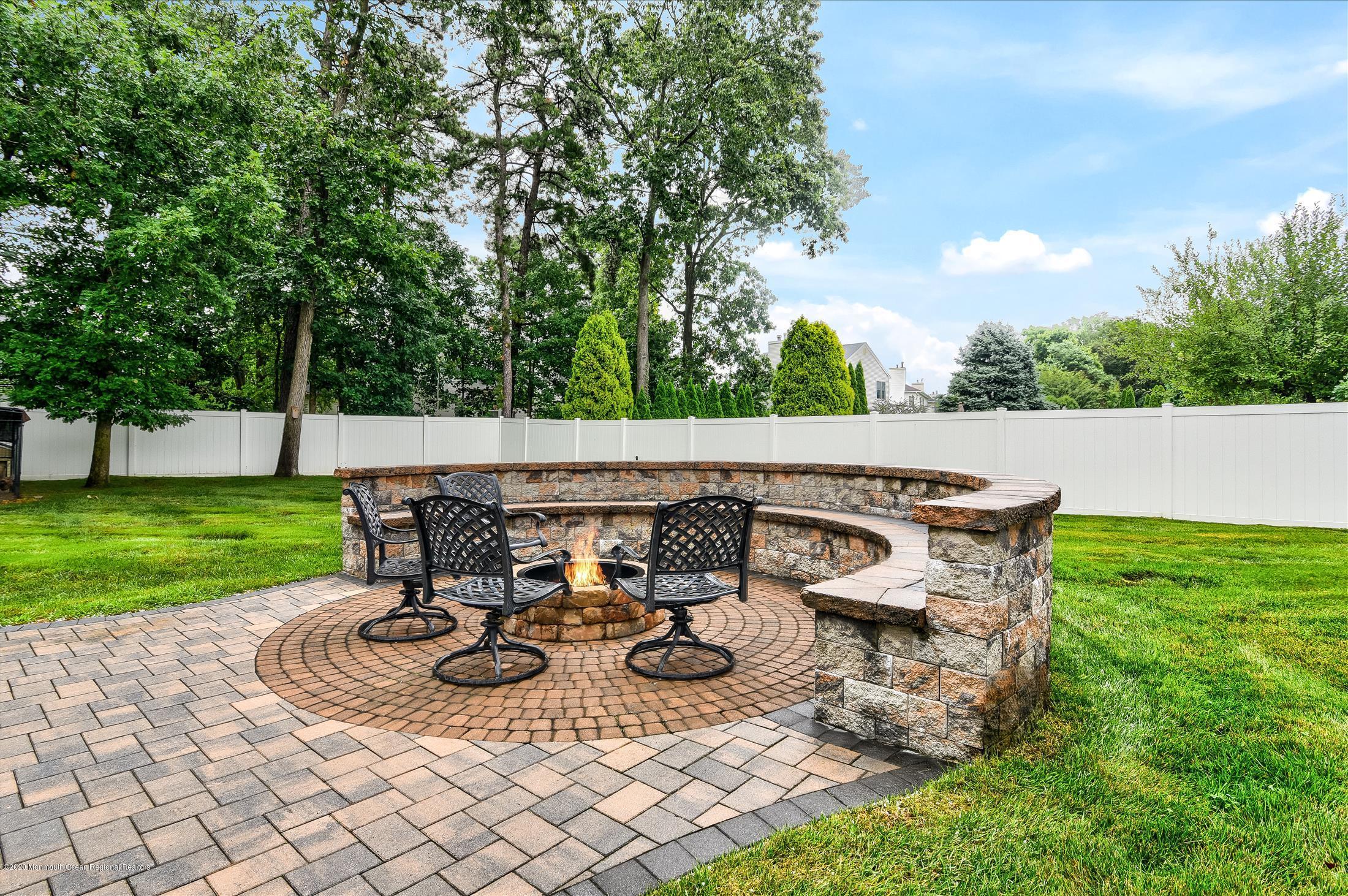 11 Sun Hollow Road Howell, NJ 07731 - Photo 24 of 27 a view of a patio with table and chairs with plants and trees