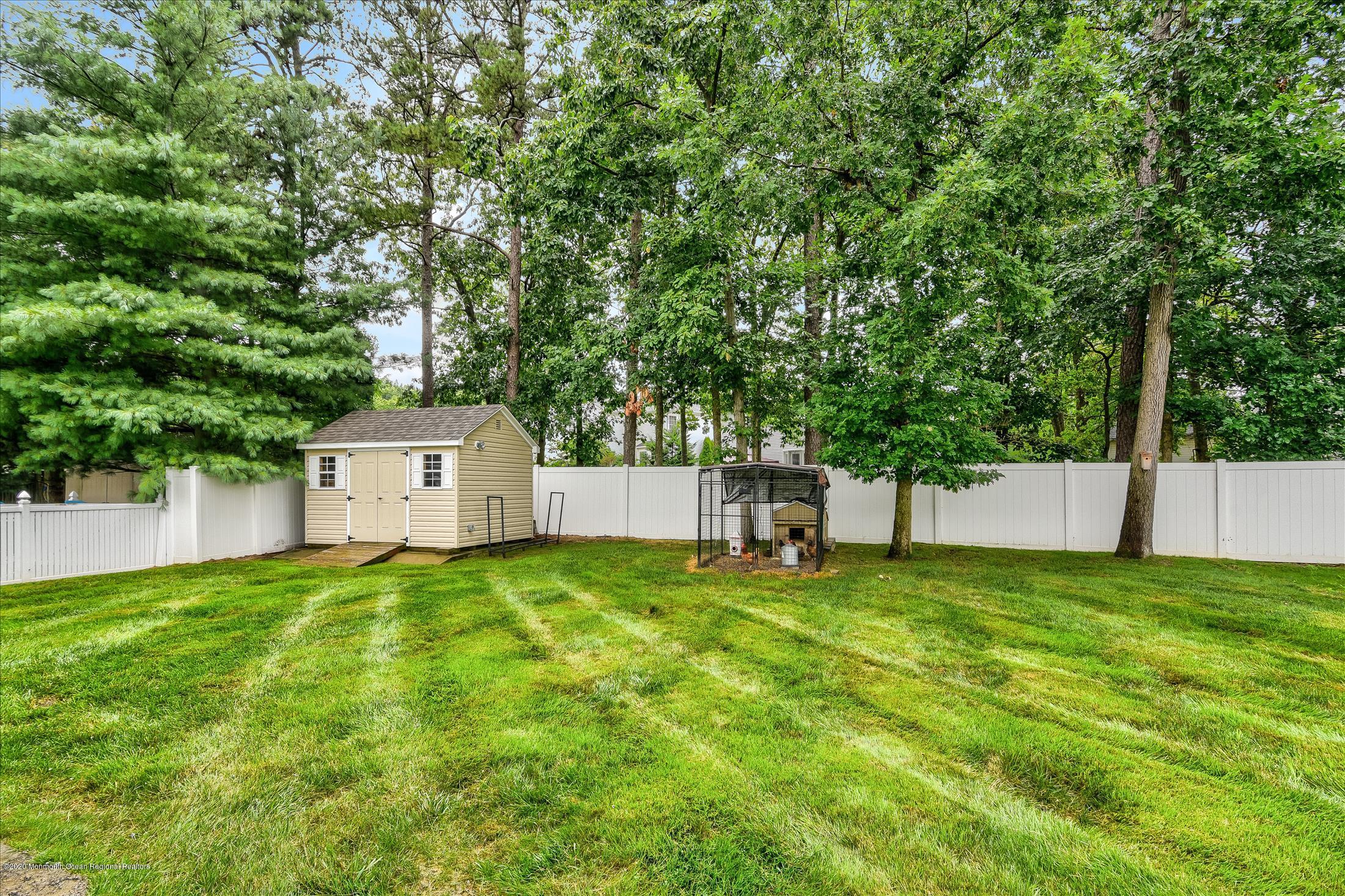 11 Sun Hollow Road Howell, NJ 07731 - Photo 26 of 27 a view of a house with a yard and a large tree