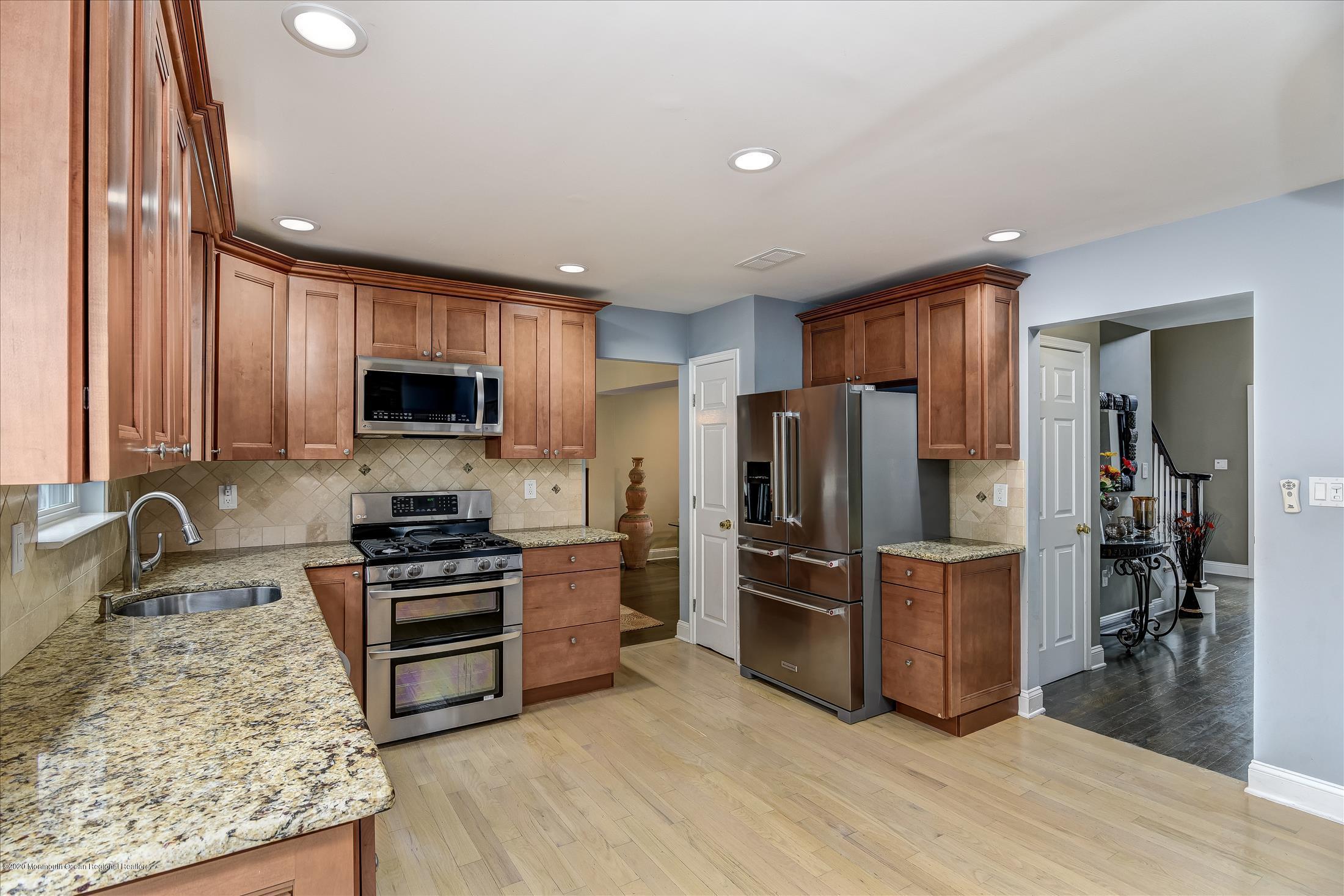 11 Sun Hollow Road Howell, NJ 07731 - Photo 8 of 27 a kitchen with stainless steel appliances granite countertop a refrigerator stove and sink