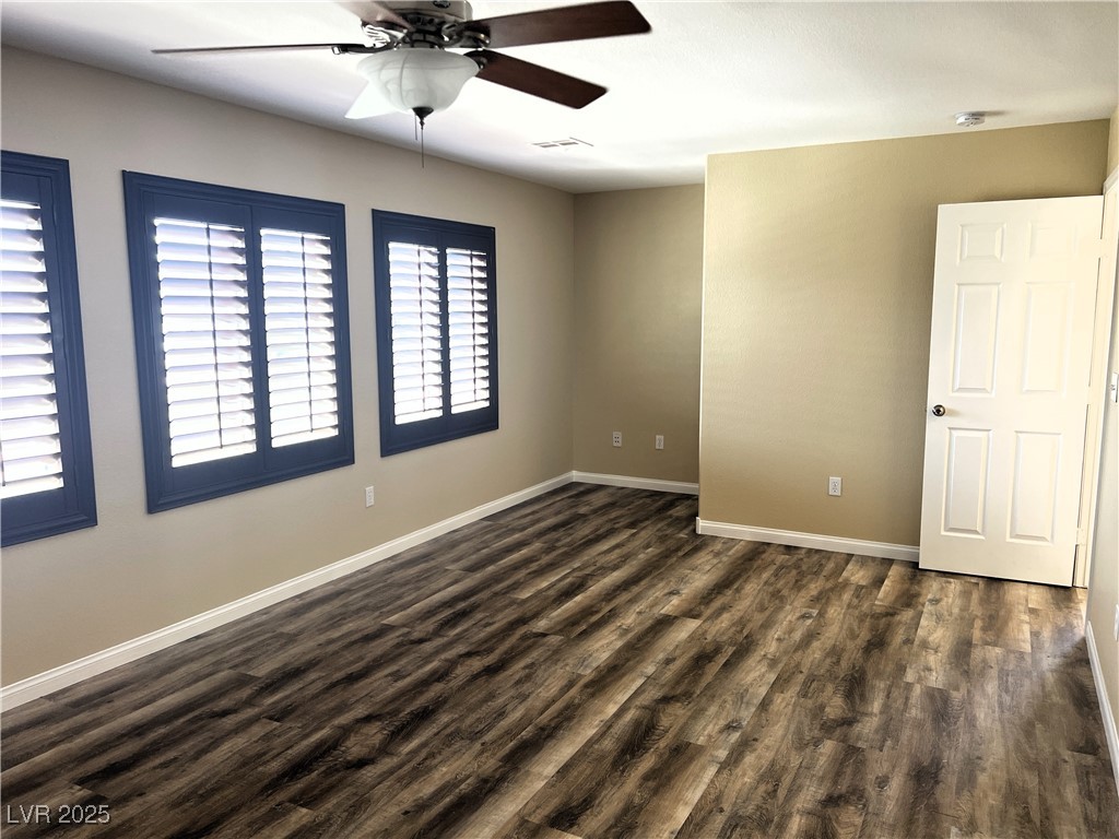 9535 Leaping Lizard Street Las Vegas, NV 89178 - Photo 8 of 37 Primary bedroom with wood-style LVP flooring, ceiling fan, shutters and plenty of natural light