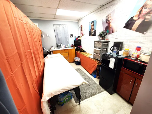 a living room with blue lights with furniture and flat screen tv