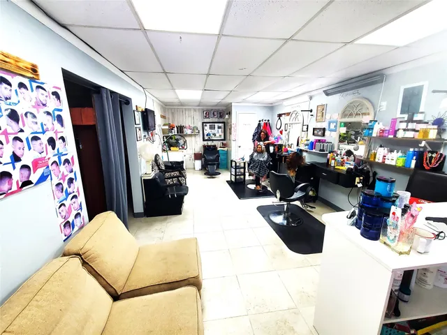 a living room with lots of furniture and refrigerator