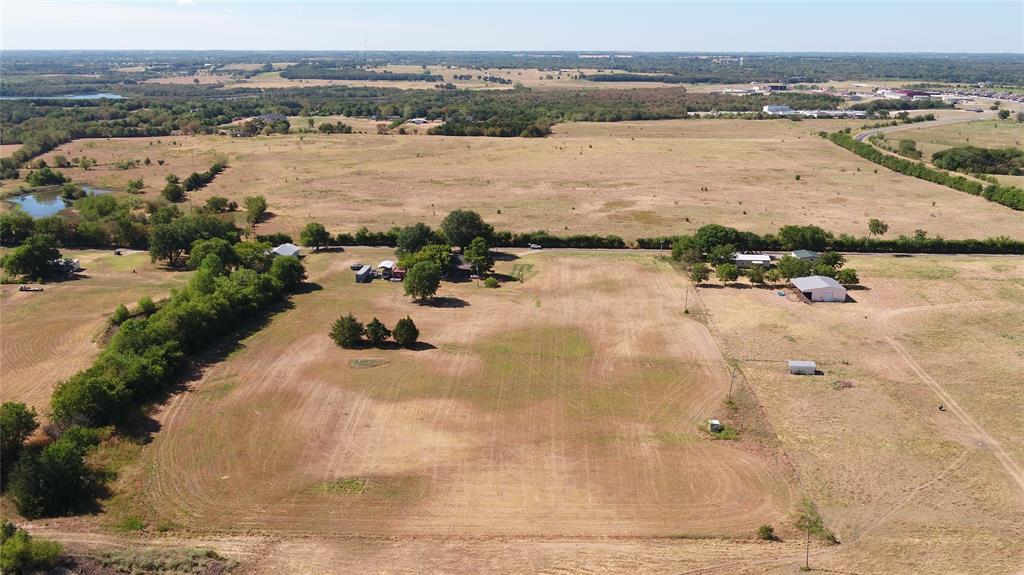 Tbd Gilliam Road Bells, TX 75414 - Photo 9 of 9 Expansive land parcel with multiple structures, including a primary residence and outbuildings, surrounded by open fields and mature trees