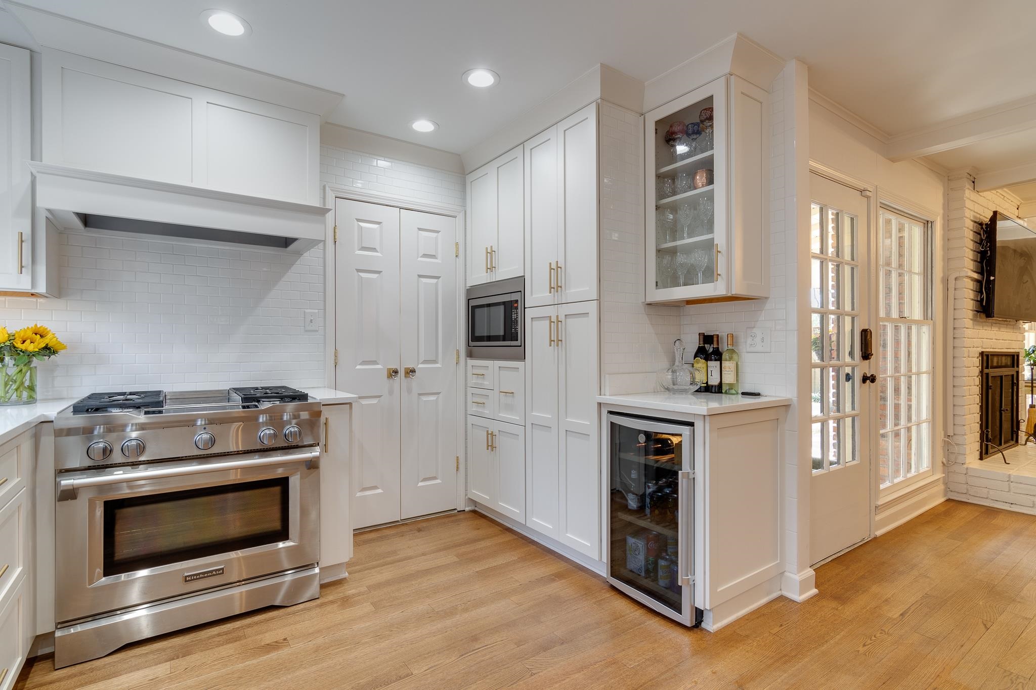 6417 Wood Bridge Road Memphis, TN 38119 - Photo 6 of 25 Stainless steel gas range, built in microwave, and under counter wine refrigerator, all thoughtfully placed near the pantry cabinets, complete with pull out drawers.