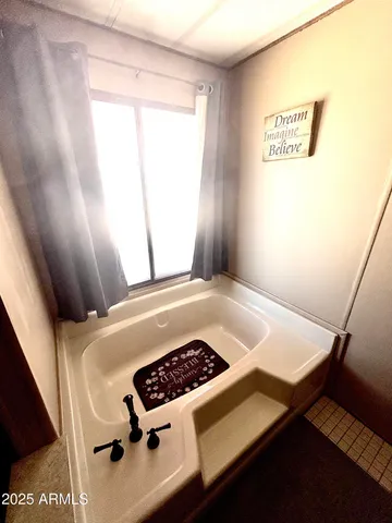 a picture of a room with bed and a window