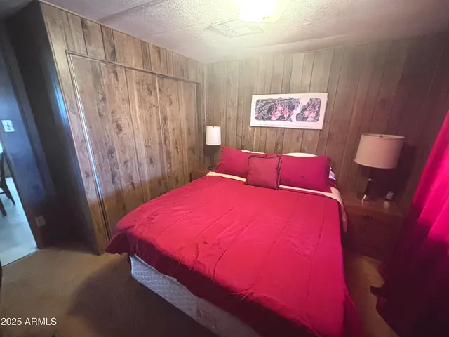 a bed room with a bed and a mirror