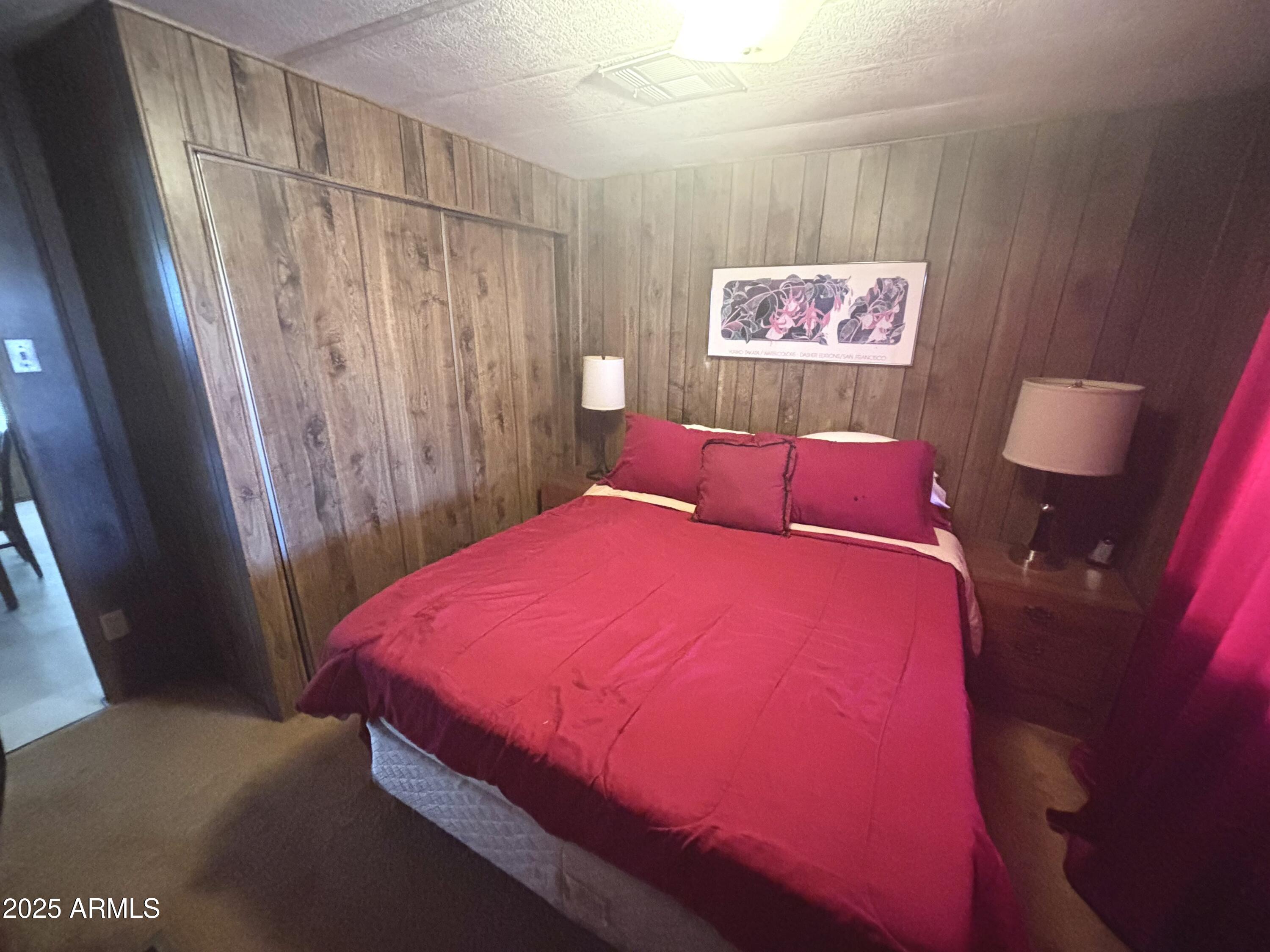 1221 West Nelson Road Ajo, AZ 85321 - Photo 15 of 17 a bed room with a bed and a mirror