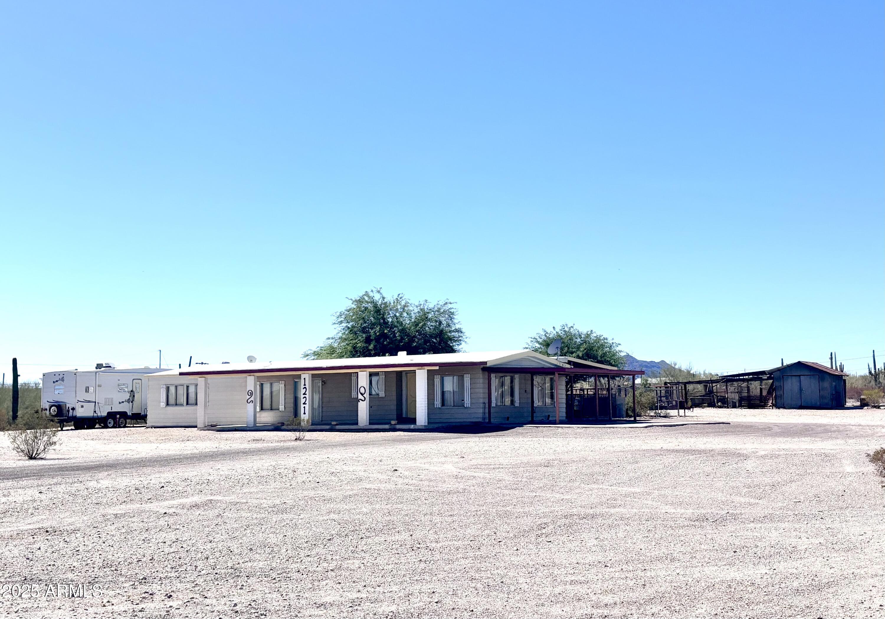 1221 West Nelson Road Ajo, AZ 85321 - Photo 2 of 17 a view of a swimming pool and a yard