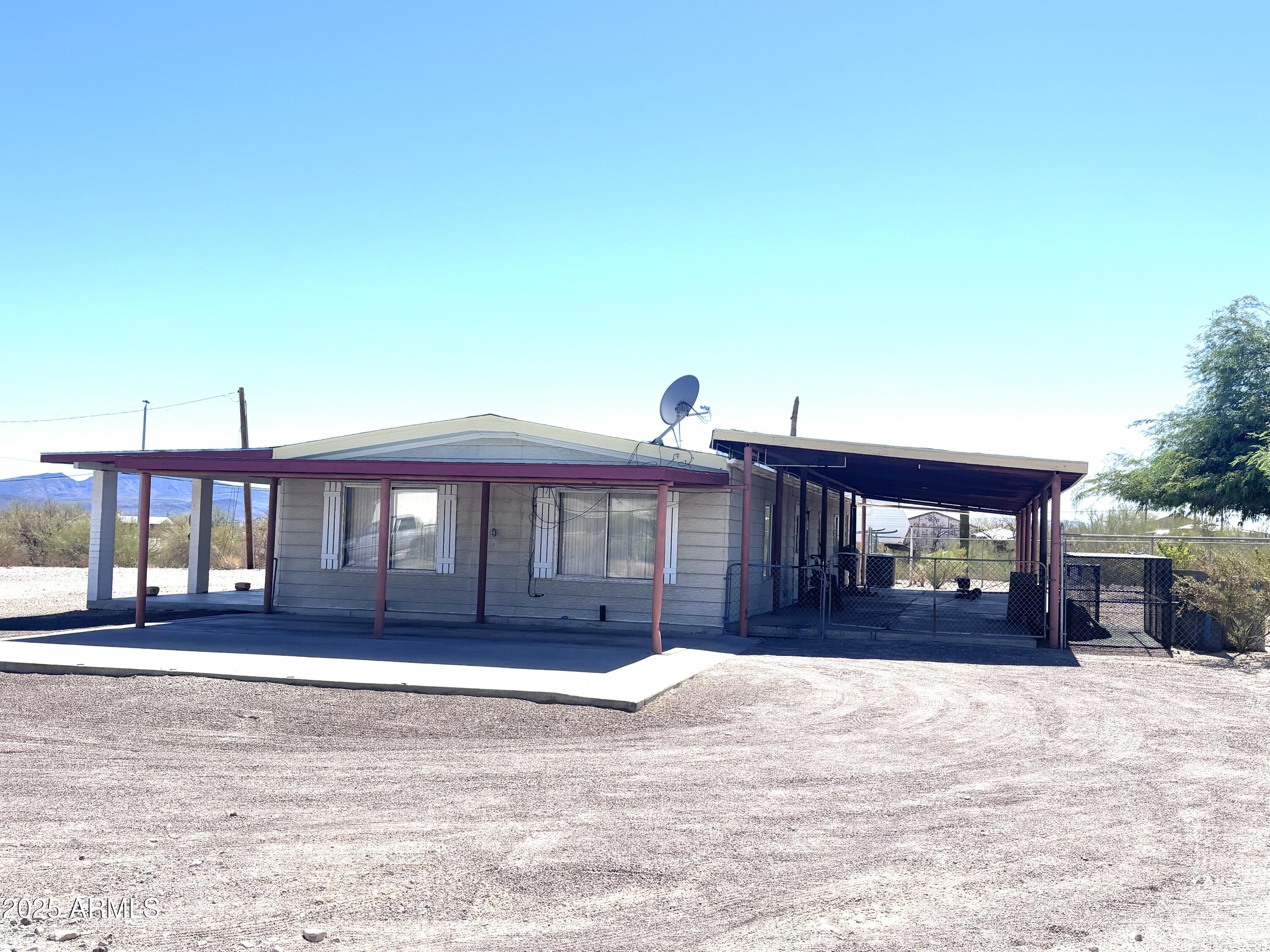 1221 West Nelson Road Ajo, AZ 85321 - Photo 4 of 17 a front view of a house with a yard