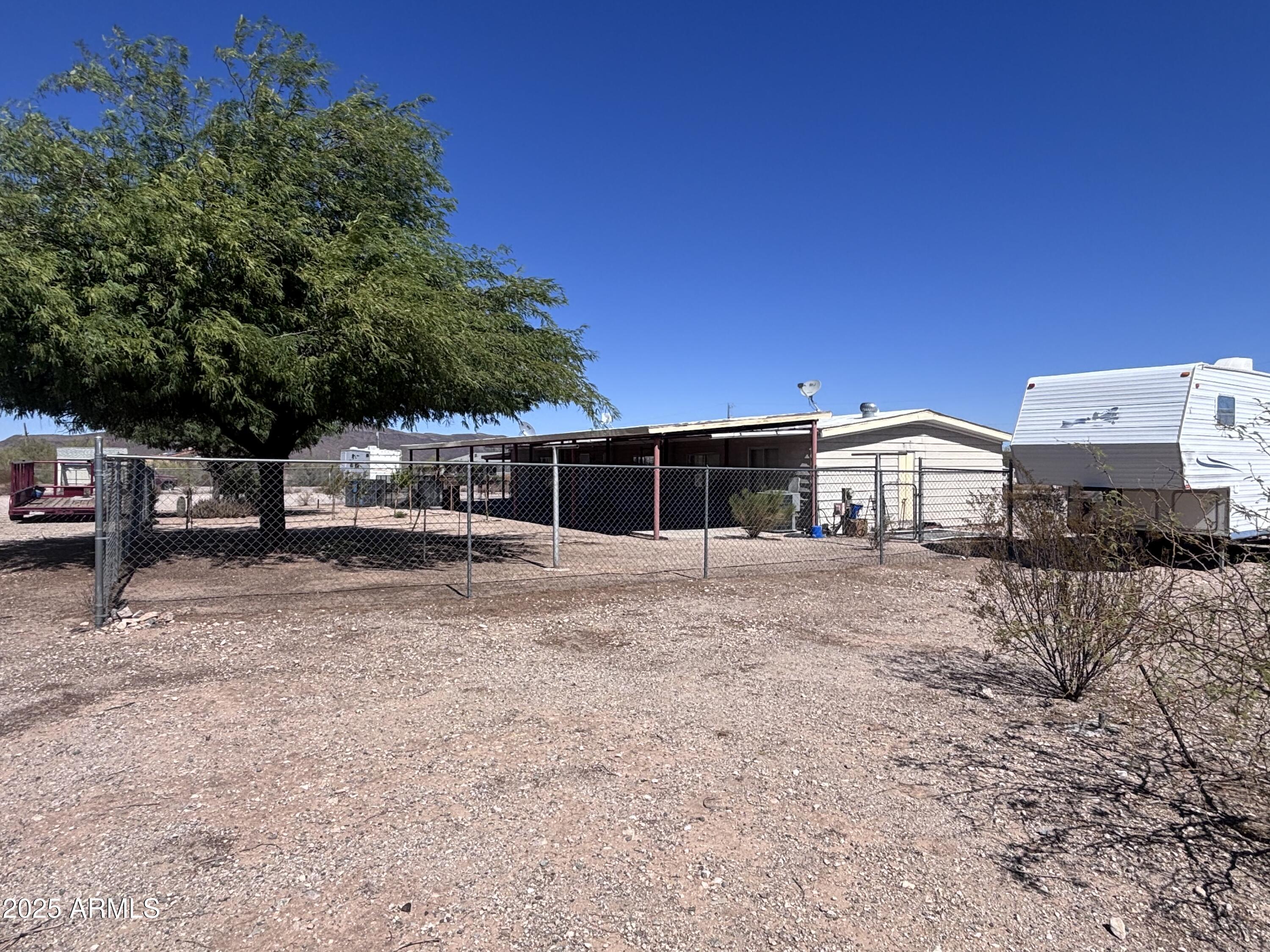 1221 West Nelson Road Ajo, AZ 85321 - Photo 6 of 17 a front view of a house with a yard