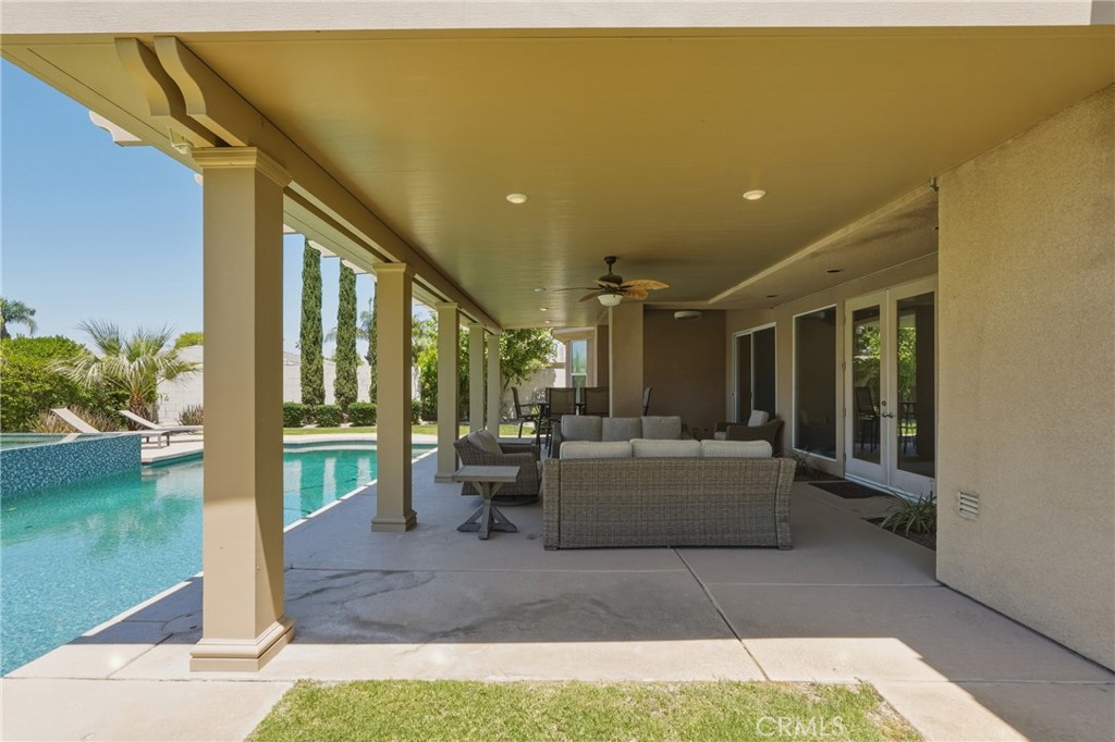 9 Orleans Road Rancho Mirage, CA 92270 - Photo 62 of 71 a living room with couch and a floor to ceiling window