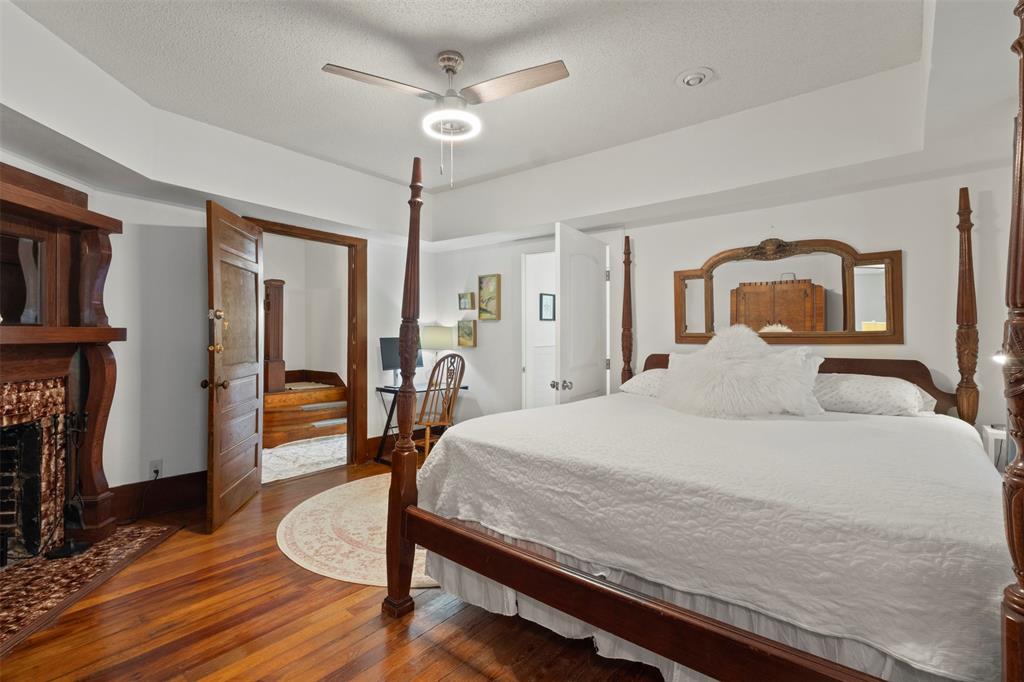 7090 Maple Street Frisco, TX 75033 - Photo 25 of 40 the 1st floor primary bedroom w fireplace