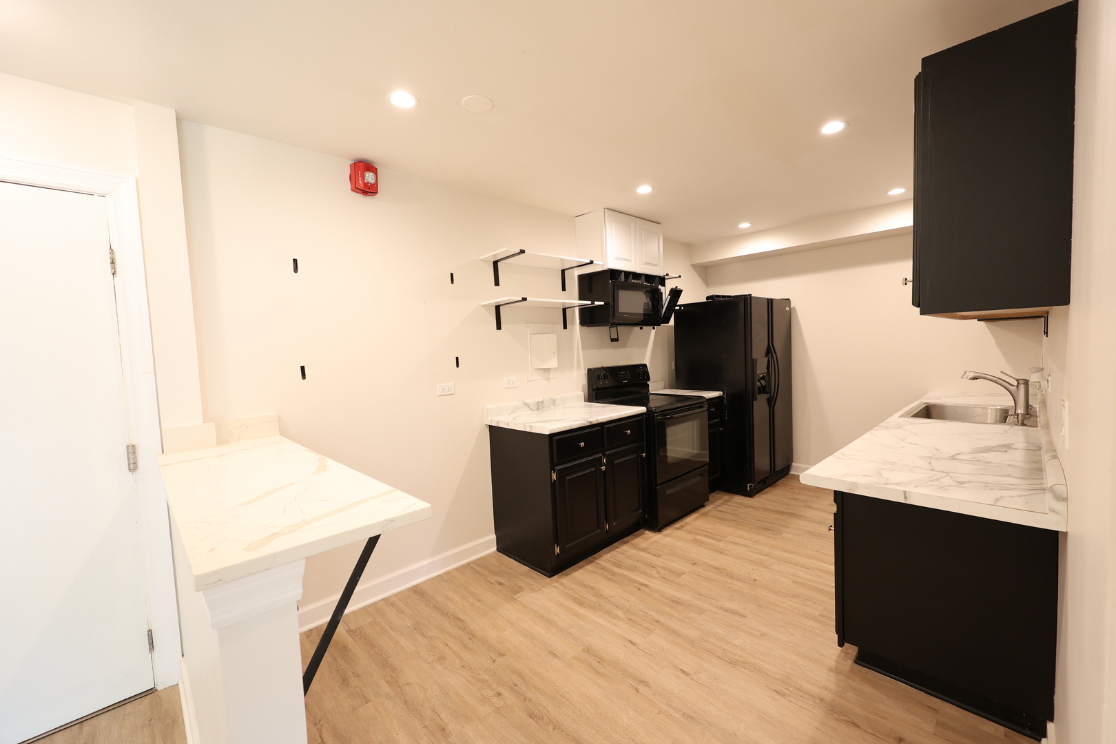 2230 South Goebbert Road, Unit 139 Arlington Heights, IL 60005 - Photo 8 of 14 a kitchen with stainless steel appliances kitchen island sink refrigerator and stove