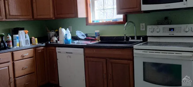 a kitchen with stainless steel appliances granite countertop a refrigerator stove and a sink with cabinets