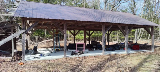 a view of a patio with table and chairs under an umbrella