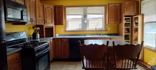 a kitchen with a sink cabinets and appliances